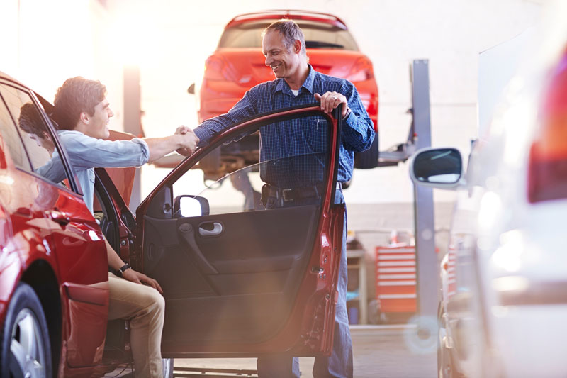 Mechanic shaking hands with a customer